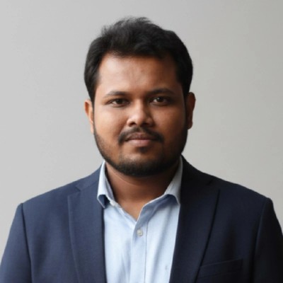 A professional headshot of a young South Asian man, Hamid Ullah Arman, wearing a casual button-down shirt. He looks thoughtful and analytical. The background features subtle hints of modern technology or engineering equipment, softly blurred. Bright, clean light mode aesthetic. - Punosristi Bangladesh Plastic Recycling